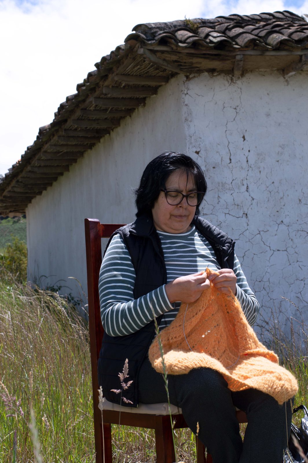 An artisan hand-knitting a baby alpaca garment in Imbabura, Ecuador